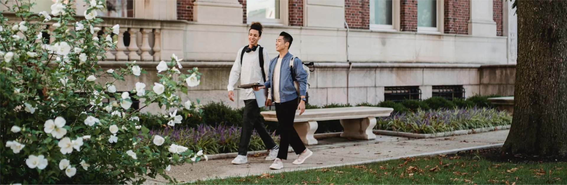 2 people walking on campus
