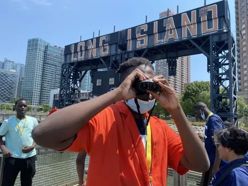 student looks out binoculars