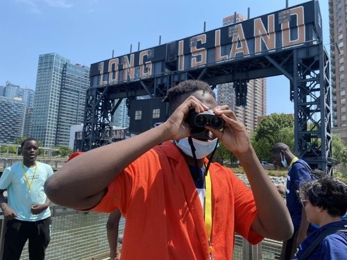 student looks out binoculars