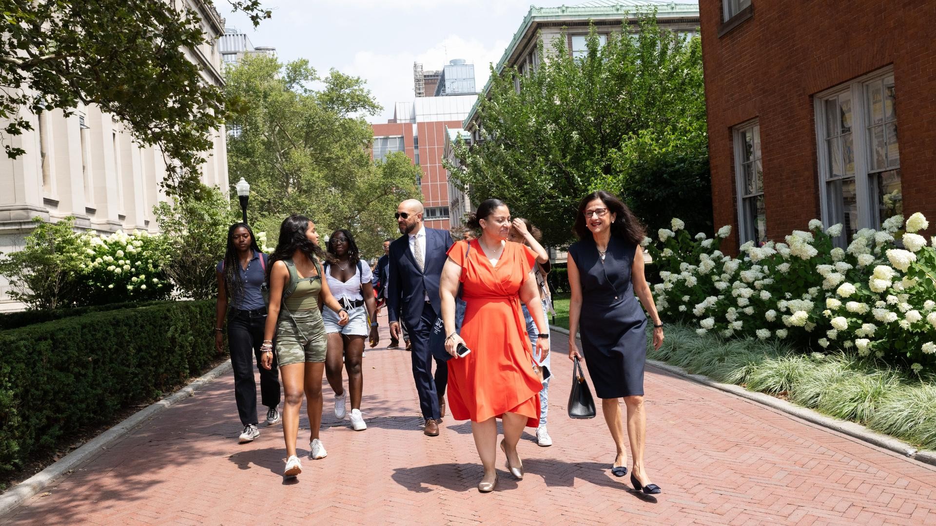 President Minouche Shafik walks with Executive Director of the DDC, Sasha Wells, along with DDC students.